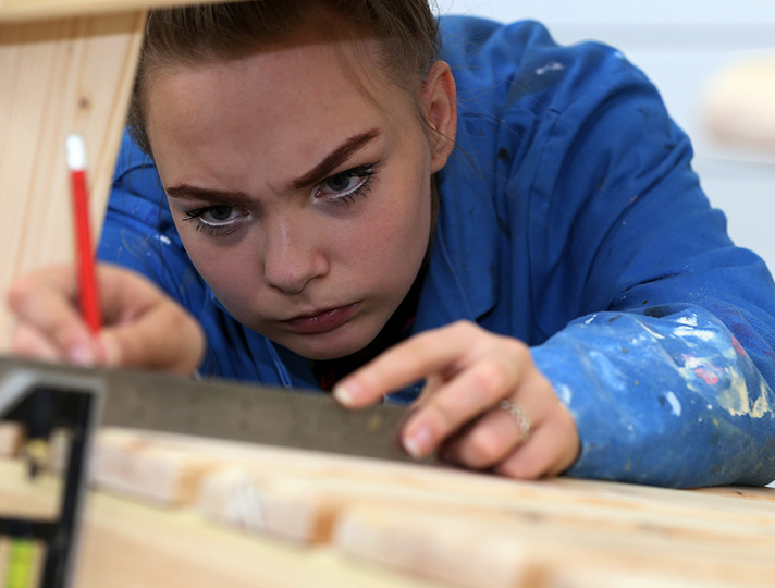 Student working in the woodworking studio