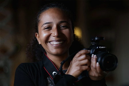 Student holding a Digital camera